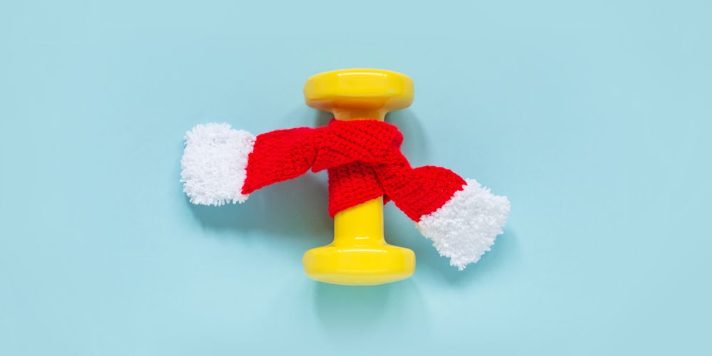 yellow barbell wrapped in red and white scarf