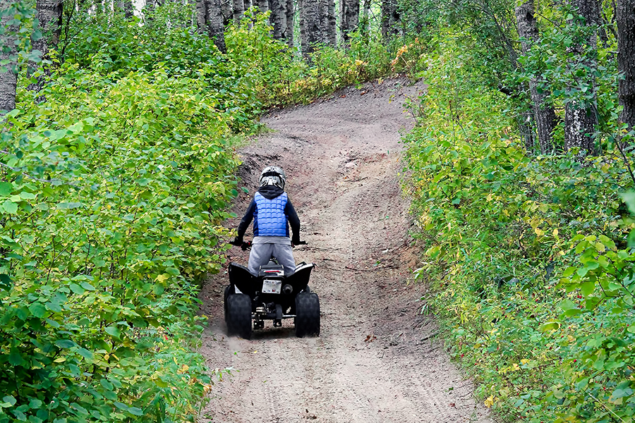 all terrain vehicle rider in forest