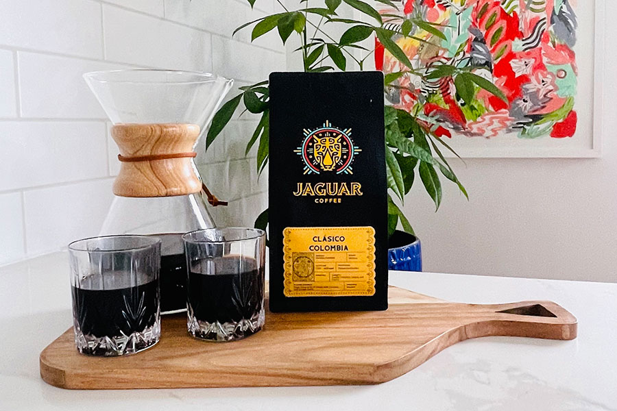 jaguar coffee beans with pot and glasses of coffee