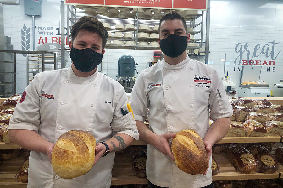 Bakers holding bread
