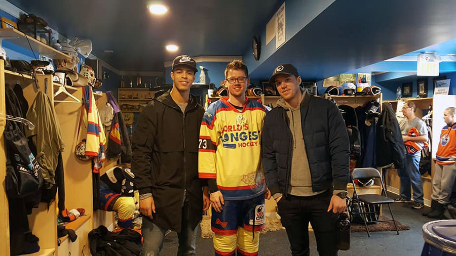 Adam Humeniuk with Edmonton Oilers Darnell Nurse and Connor McDavid at the World's Longest Hockey game at Saiker's Acres