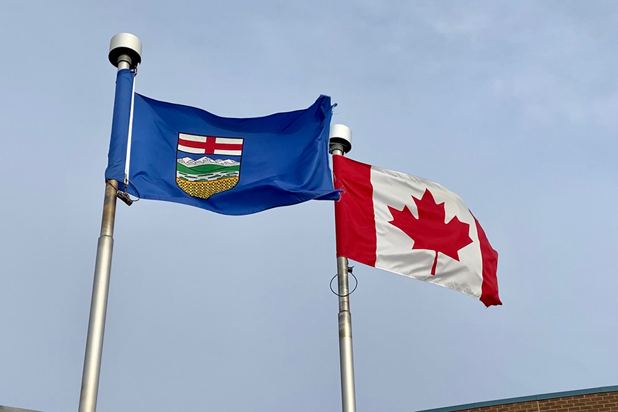 alberta and canada flags flying side by side