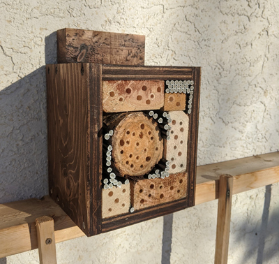 bee hotel installed beside a house