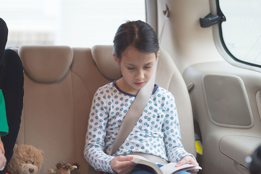 child reading in vehicle