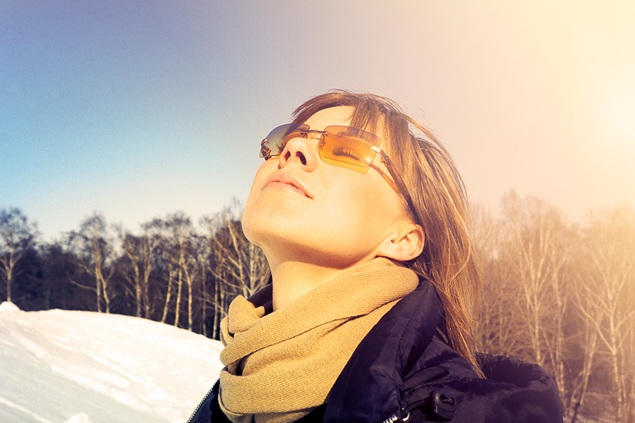 woman in sunglasses enjoying the sunshine