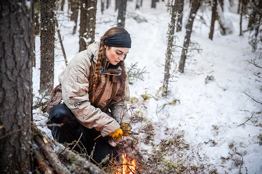 NAIT Conservation Biology student builds a fire in a survival situation