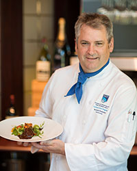NAIT Culinary Arts instructor Norman Brownlee with a surprising and savoury chocolate and salmon dish.
