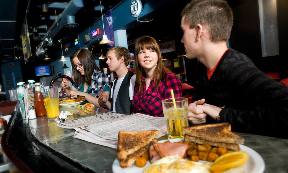 students eating and talking at the nest, nait's campus bar and restaurant