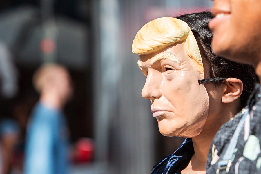 person wearing a donald trump mask