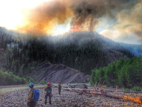 peace river unit fighting a wildfire on the Alberta-B.C. border