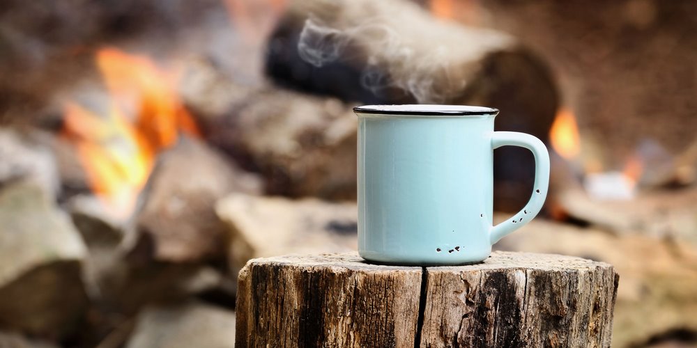 steaming coffee cup at camp site