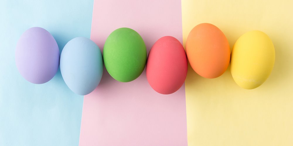 different coloured easter eggs arranged in an uneven row